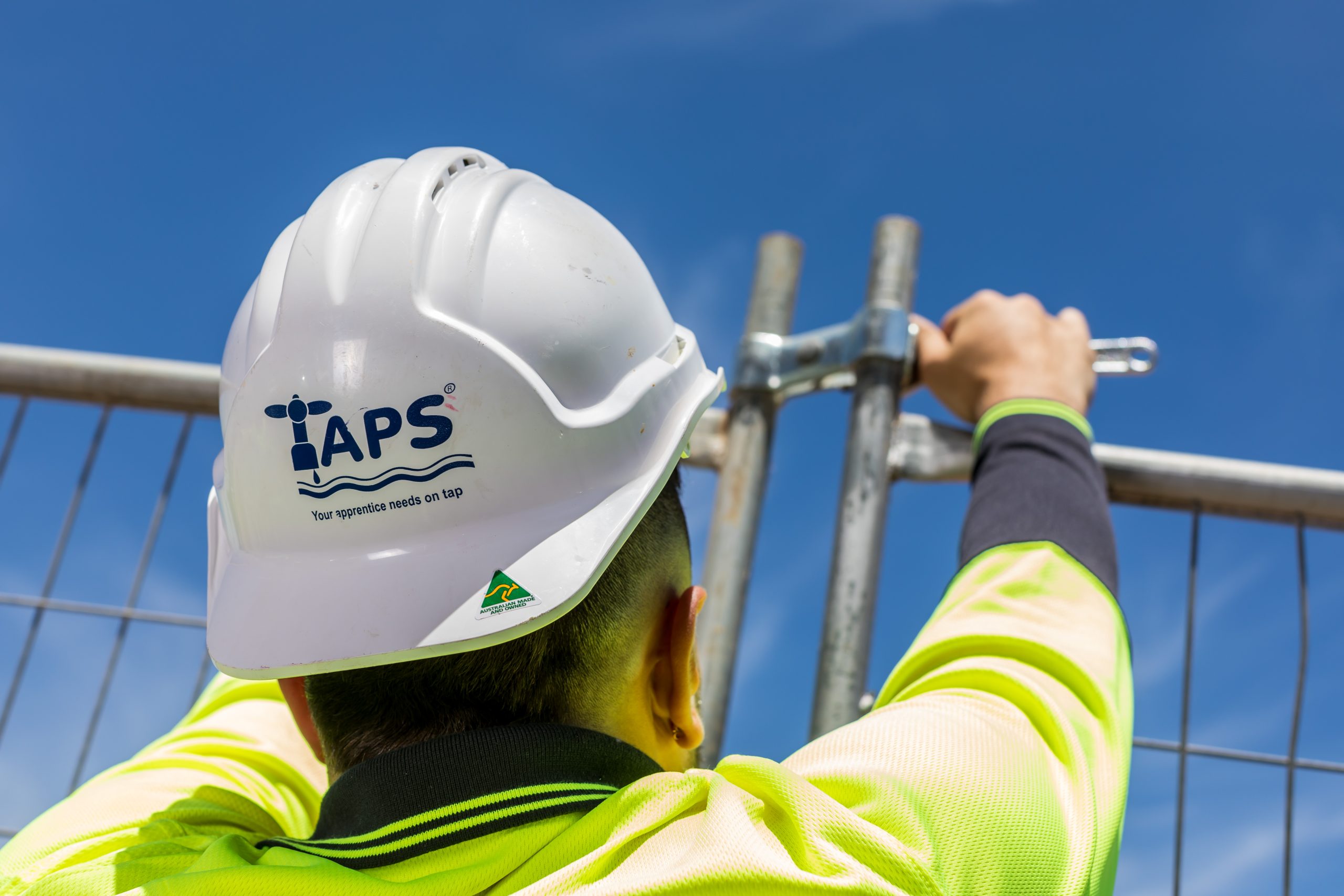A TAPS student working on a fence.